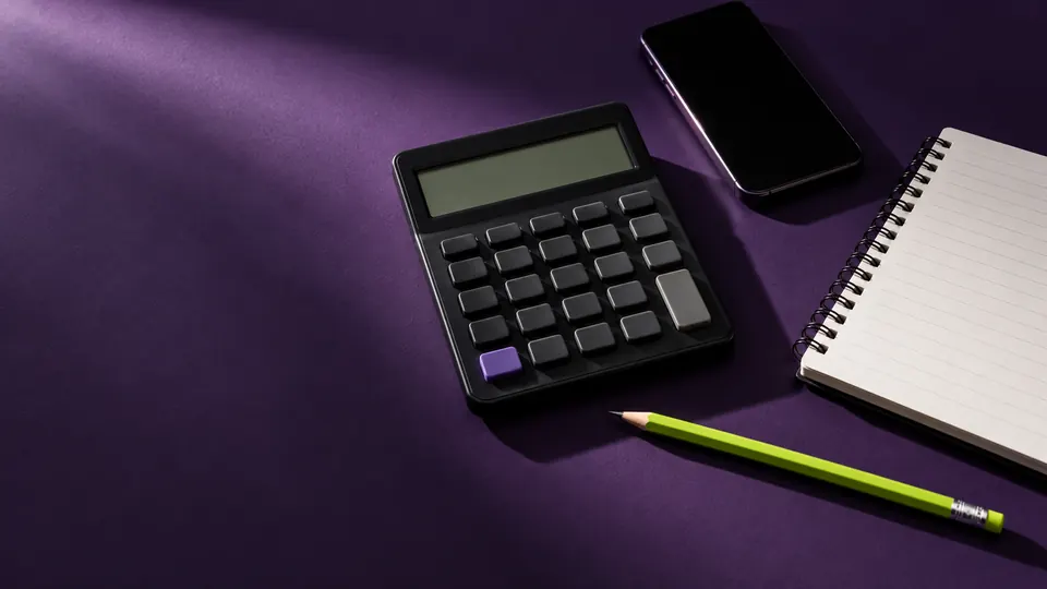 Calculator, phone and notepad on a purple desk